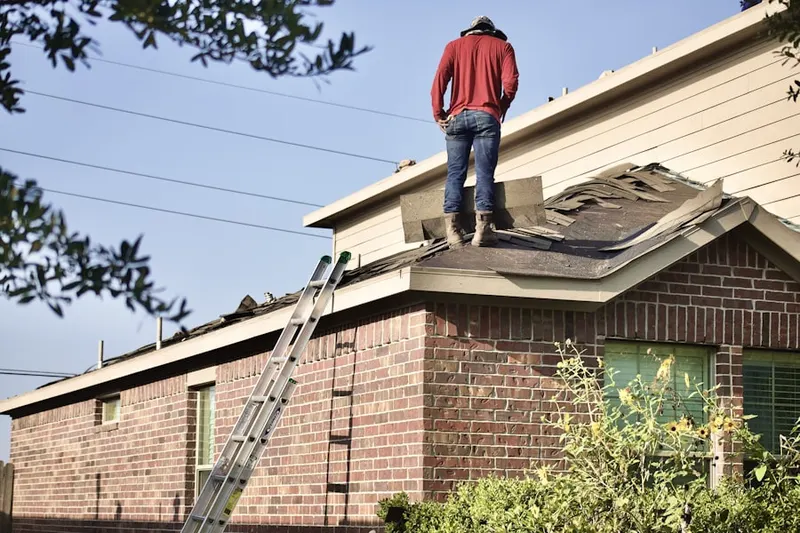 Professional roofer working on a residential roof in White Sulphur